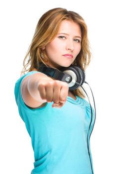 Young woman is showing a fist, isolated over white
