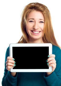 Young cheerful woman is showing blank tablet, isolated over white