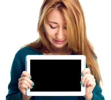 Young cheerful woman is showing blank tablet, isolated over white