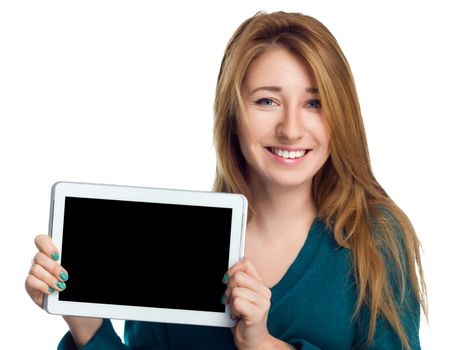 Young cheerful woman is showing blank tablet, isolated over white
