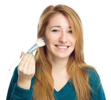 Girl is applying makeup using brush, isolated over white