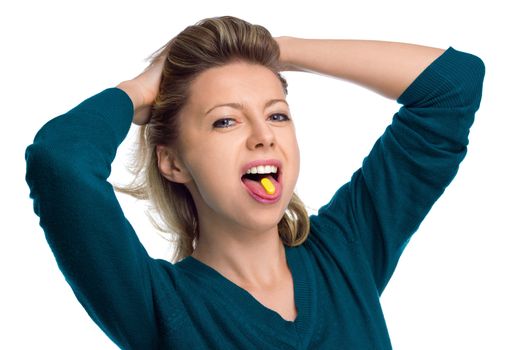 Beautiful woman with pill on her tongue isolated on white background
