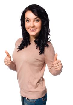 Young woman is showing thumb up gesture, isolated over white