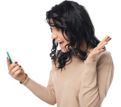 Young girl is looking on her phone, isolated over white