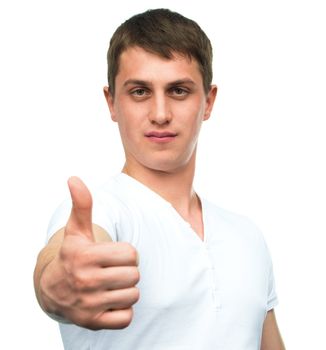 Young man shows thumb up gesture on white background