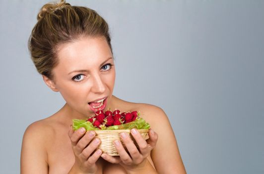 Close up of woman holding raspberries