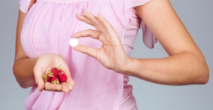 Woman hold on palm raspberries and tablet