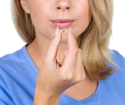 Closeup picture of woman with vitamins isolated over white