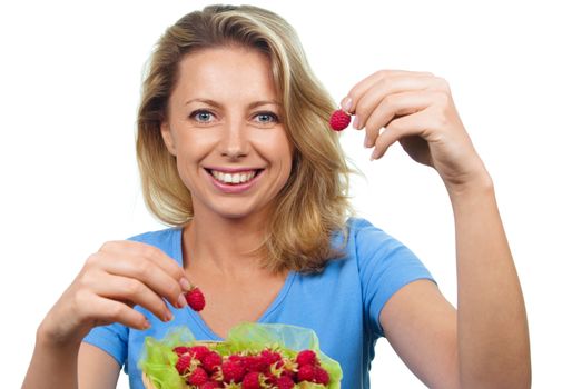 Close up of smiling woman holding raspberries isolated on white