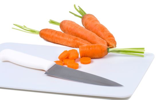 Carrot and knife on cutting board isolated over white