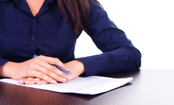 Woman in blue shirt signs a contract on a table, isolated over white