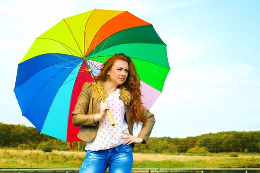 Portrait of a pretty woman with colorful umbrella, outdoor shots