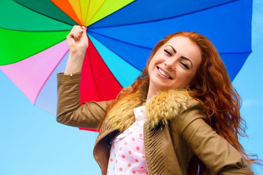 Portrait of a pretty woman with colorful umbrella, outdoor shots