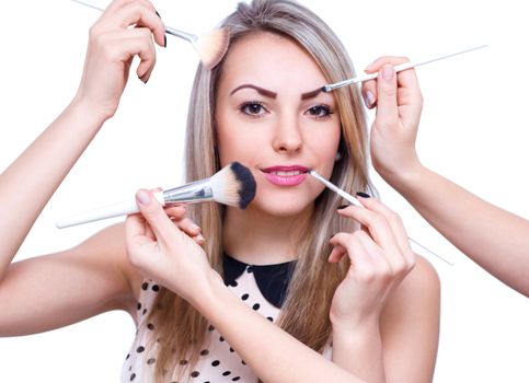 Make up woman with many hands. Makeup brushes. Isolated on white background
