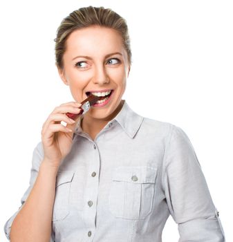 portrait of a young woman biting chocolate isolated on white background