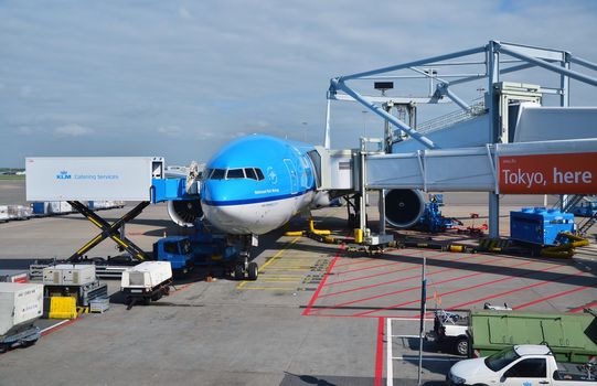 Amsterdam, Netherlands - May 16, 2015: Plane at Schiphol Airport on May 16, 2015 in Amsterdam, Netherlands. The airport handles over 45 million passengers per year with almost 100 airlines flying from here.