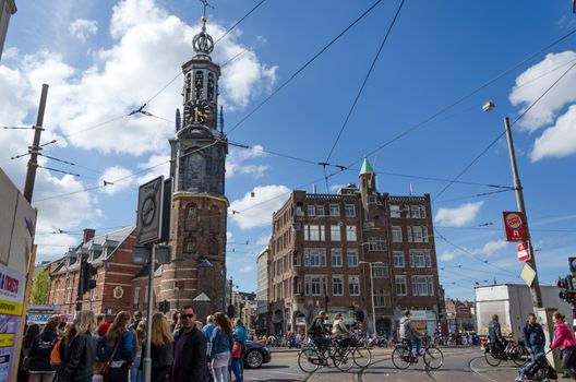 Amsterdam, Netherlands - May 8, 2015: People at The Munttoren (Mint Tower) Muntplein square in Amsterdam, This tower was once part of one of the three main medieval city gates.