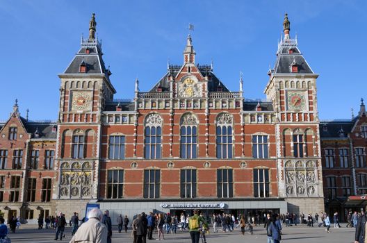 Amsterdam, Netherlands - May 8, 2015: People at Amsterdam Central Train Station on May 8, 2015 in Amsterdam, Netherlands. Amsterdam Central Station is used by 250,000 passengers a day.