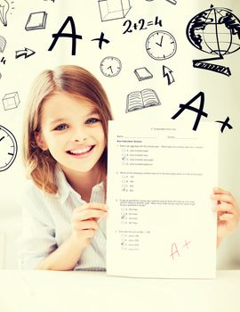 education and school concept - little student girl with test and A grade at school