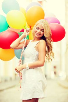 summer holidays, celebration and lifestyle concept - beautiful woman with colorful balloons in the city