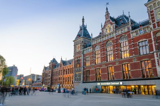 Amsterdam, Netherlands - May 8, 2015: People at Amsterdam Central Train Station on May 8, 2015 in Amsterdam, Netherlands. Amsterdam Central Station is used by 250,000 passengers a day.