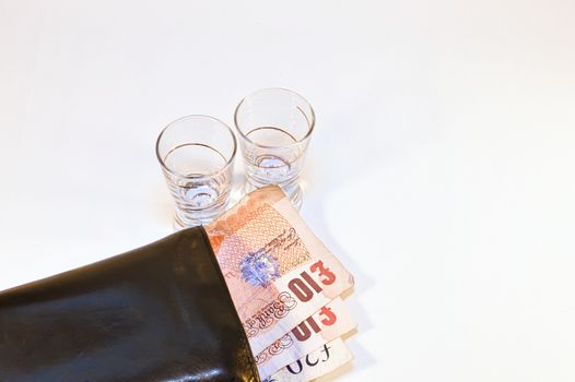 two vodka glasses on banknotes ten pounds