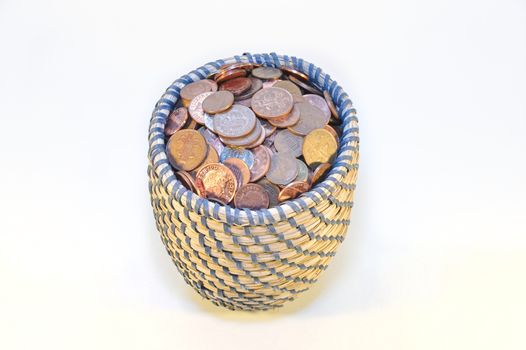 coins in basket and british banknotes