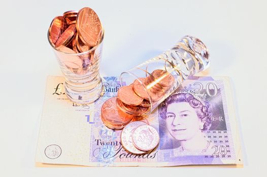 two vodka glasses on banknotes ten pounds