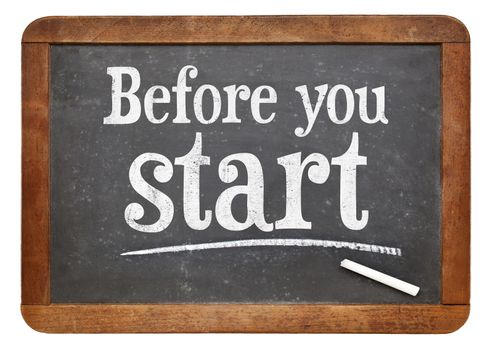 Before your start  sign - white chalk text  on a vintage slate blackboard