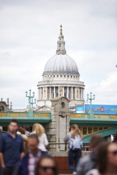 LONDON, UK - JUNE 23: Dome of Saint Paul's cathedral seen from Blackfriars, with blurred people in the foreground. June 23, 2015 in London.
