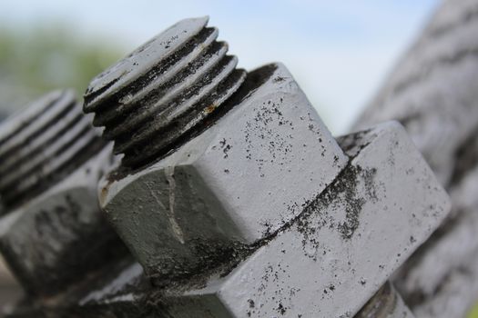 Large bolts, nuts and steel wire rope. Elements of fastening of bridge.