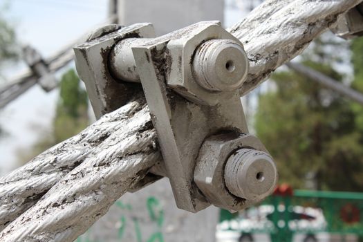 Large bolts, nuts and steel wire rope. Elements of fastening of bridge.