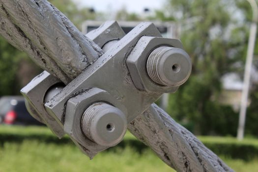 Large bolts, nuts and steel wire rope. Elements of fastening of bridge.