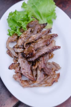 Sliced grilled Beef with fresh lettuce on dish