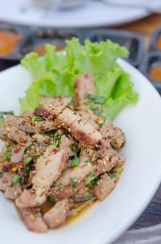 Grilled Pork Spicy Salad on white dish