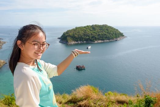Girl invited to visit the beautiful island and sea at Windmill viewpoint is a famous attractions of Phuket Province in Thailand