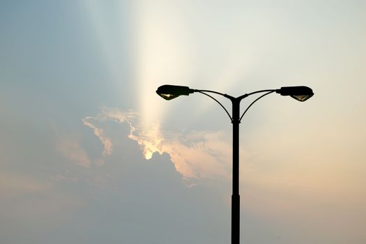 silhouette of streetlight with beautiful sunbeam background