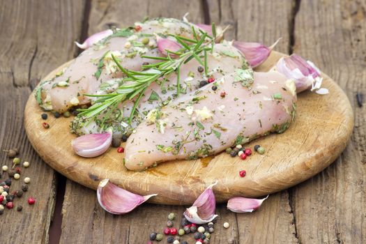 Raw chicken breast fillets with herbs and spices