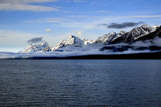 A view of the towering snowcapped peaks of the Grand Tetons in Grand Teton National Park, near Jackson Hole. Jakson Lake.