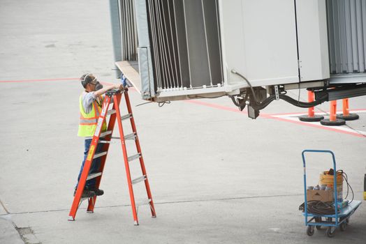 Airport worker prepares passenger ramp