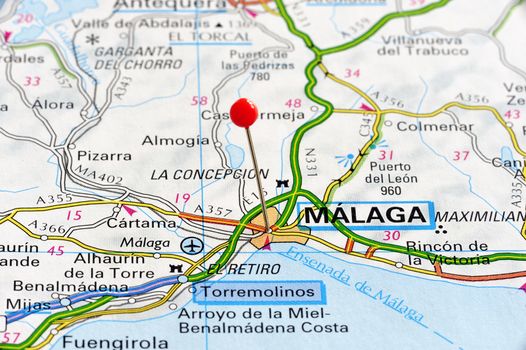 Málaga marked with red pushpin on map. Selected focus on Málaga and pushpin. Pushpin is in an angle.