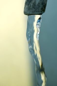 Tap of running water  on grey background