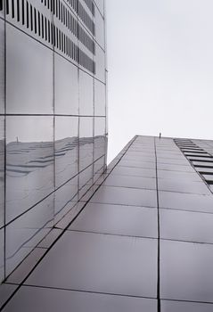 Photograph of a pair of metal buildings from a bottom perspective