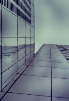 Photograph of a pair of metal buildings from a bottom perspective