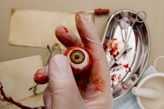 Human eye in the hand of the surgeon.