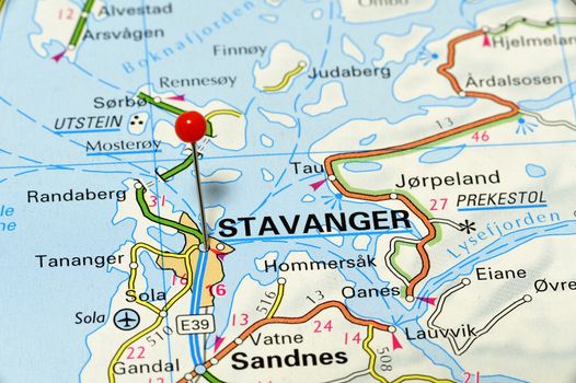 Stavanger - famous city in Norway. Red flag pin on an old map showing travel destination.