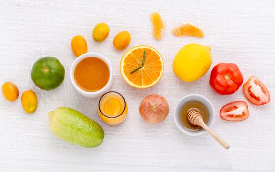 Breakfast with orange juice, oranges, oranges slice, passion fruit , ginger,tomato and Kiwi set up on wooden table .