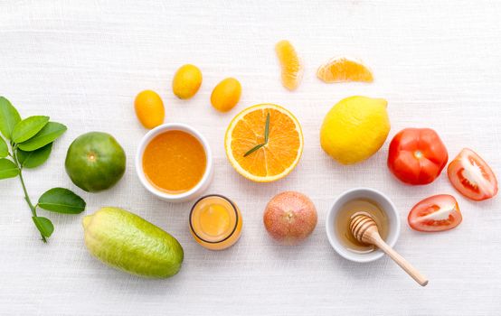 Breakfast with orange juice, oranges, oranges slice, passion fruit , ginger,tomato and Kiwi set up on wooden table .