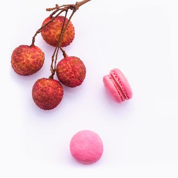 Brunch of ripe lychee and lychee macaroons with leaf isolate on white background.