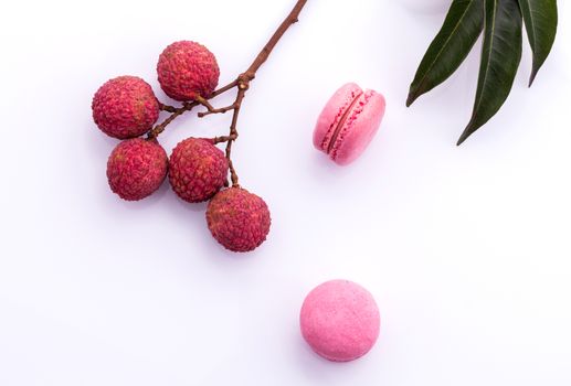 Brunch of ripe lychee and lychee macaroons with leaf isolate on white background.